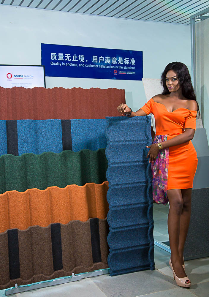 A model with Fabcom Structural Stone Coated Roofing Tiles for best roofing sheet for rainy season in Nigeria